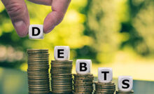 dice on cons with debts inscription on the dice to show best debt relief programs